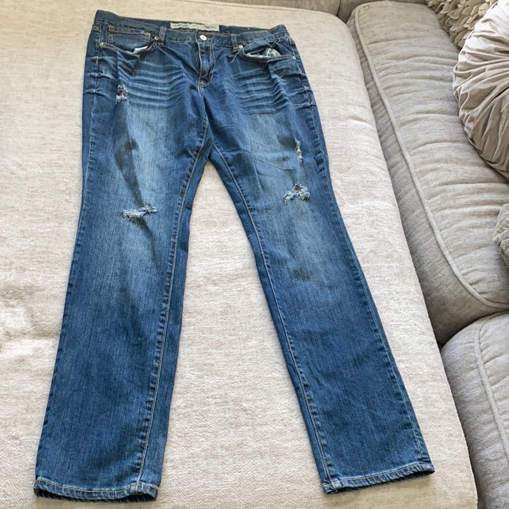 Distressed dark blue denim jeans